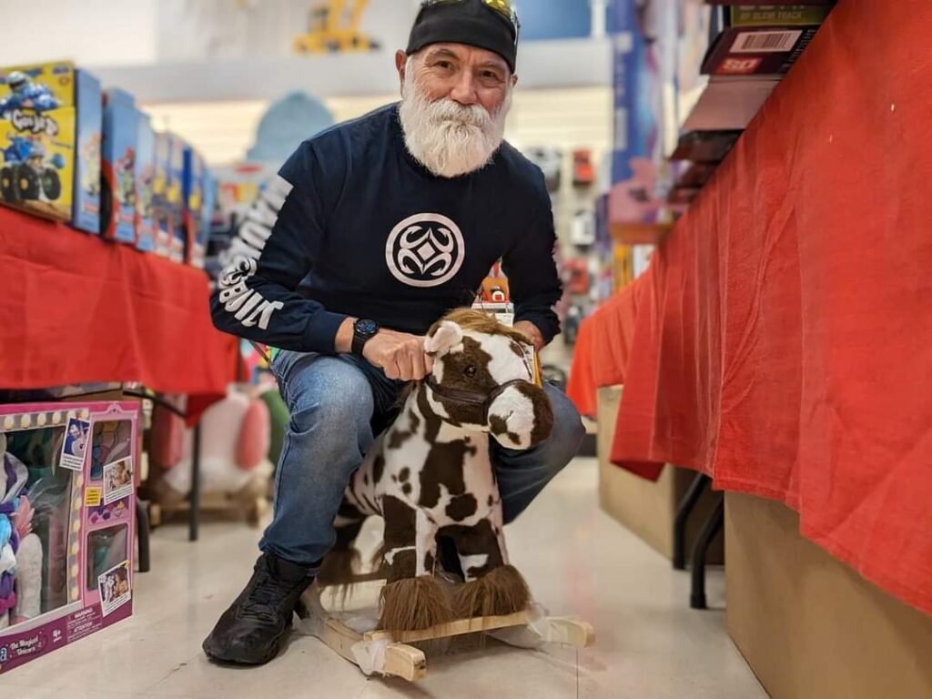 image of me on a toy hobby horse in a store. Never stop having fun moments