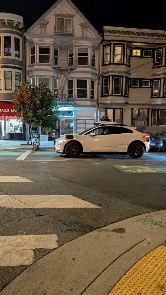 PXL_20240928_030359234.RAW-01.COVER Image of WAYMO Car that is a late model Jaguar SUV